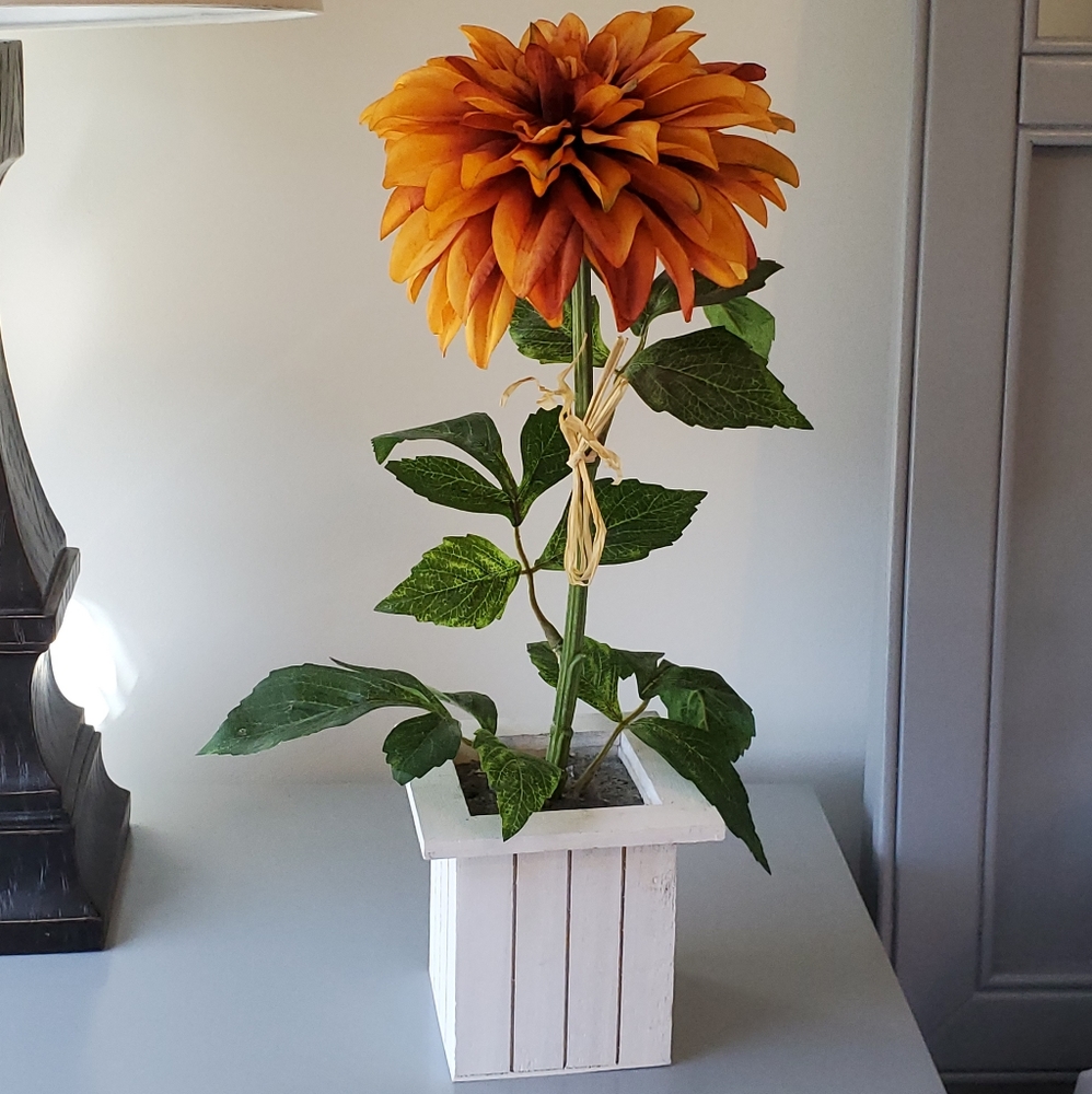 Faux yellow orange flower in vase